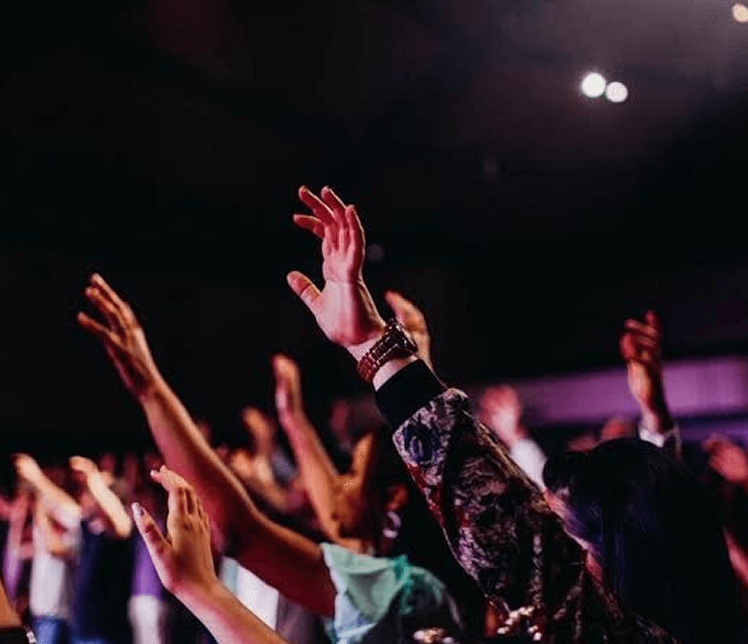 People worshipping with raised hands at Glory Tabernacle